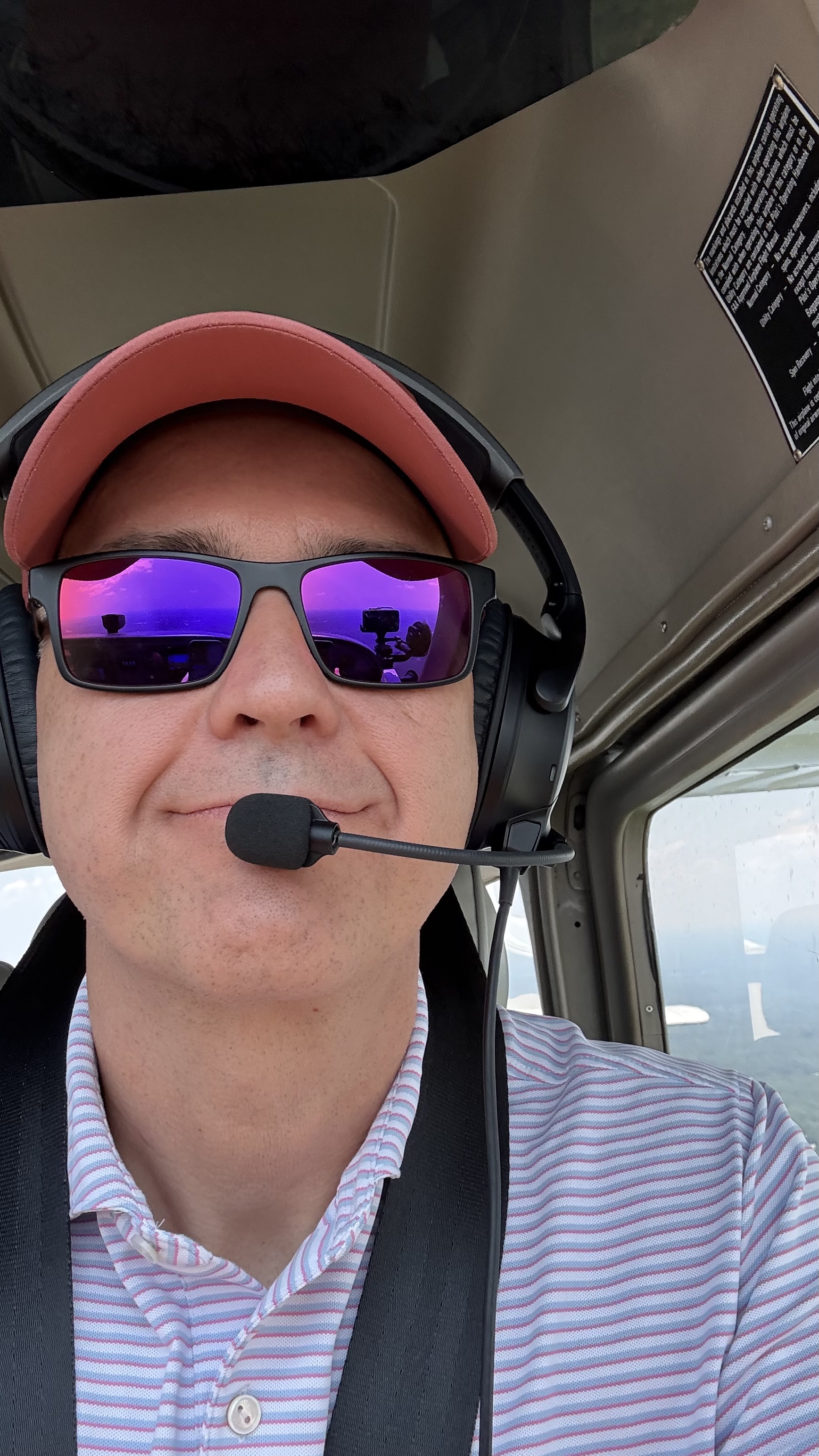 Sam LeHardy wearing a headset in an airplane cockpit.